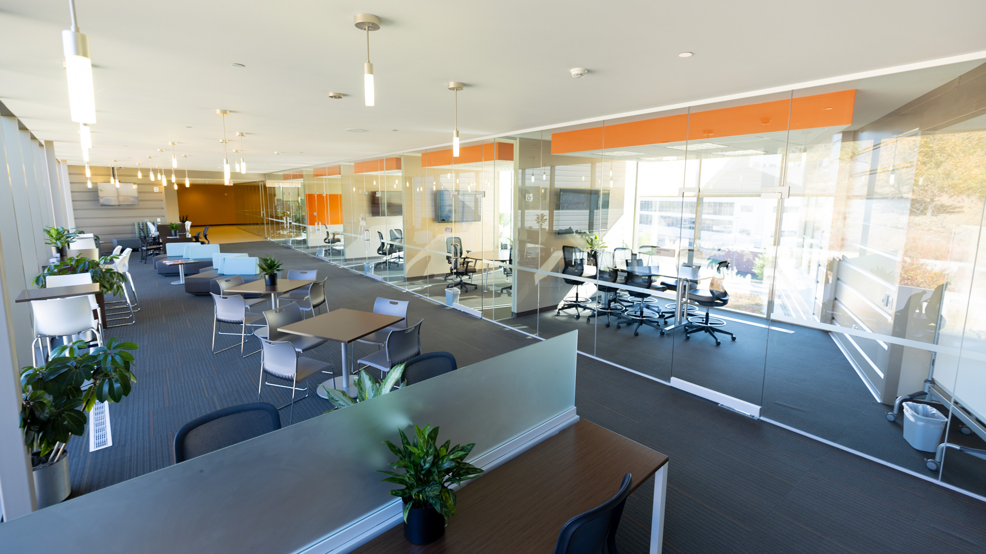 A wide shot of seating outside of offices with glass walls at the KU Innovation Park in Lawrence