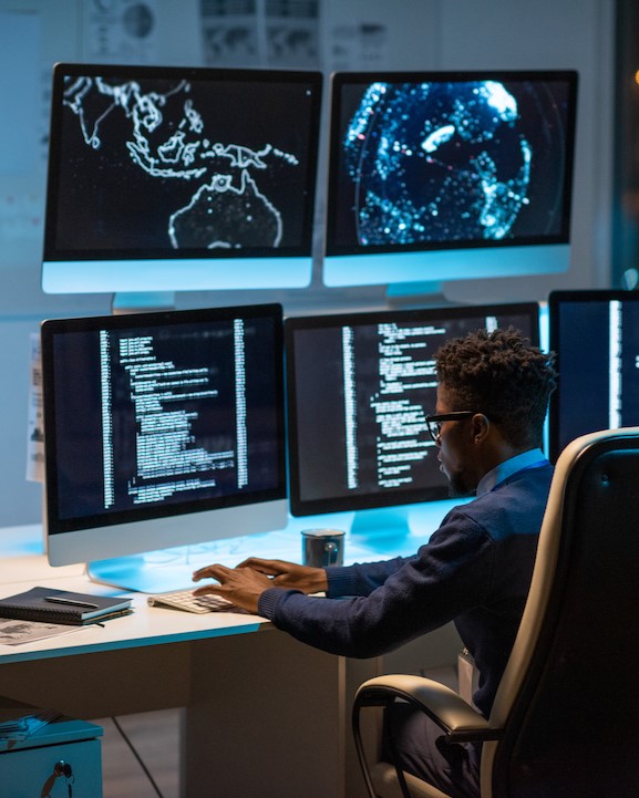 Two young scientists in protective clothing look down at papers at the Business Park in Lawrence
